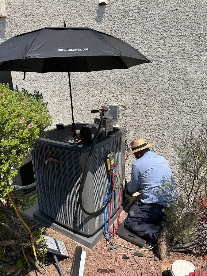 HVAC technician performing outdoor AC maintenance in Kenilworth